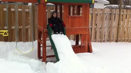 Child on slide with too much snow