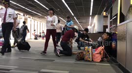 Awkward moment as man receives foot massage from woman in busy Thai airport