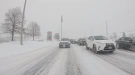 Fresh snowstorm strikes Ontario, Canada as traffic slides over roads