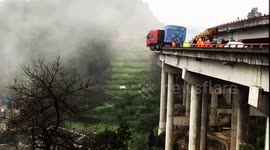 Out-of-control lorry left hanging off bridge edge in China