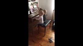 Identical twin toddler sisters singing twinkle twinkle little star while “playing” the piano