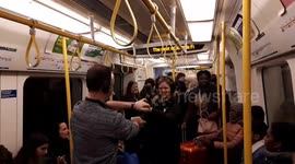Londoners dance on the Tube in flash mob