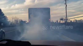 Gross polluting delivery truck belching clouds of exhaust smoke into the environment contributing to smog, global warming and climate change