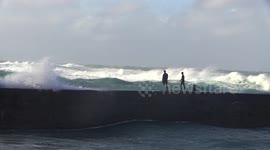 Daredevil youths plunge into rough waters as Storm Freya pounds UK
