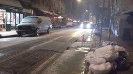 NYC: Vehicle Drives Through Falling Snow