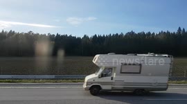 ride by remote bus on highway, passenger view of Swedish landscape in early spring
