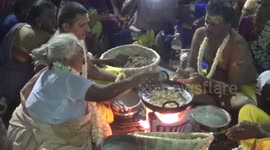 84-year-old woman stunned thousands of devotees on festival day by frying pancakes in boiling oil using her bare hands in southern India.