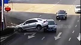 Distracted driver nearly flips car on embankment and lands on second vehicle