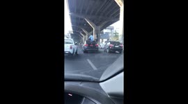 Bizarre moment BMW driver sits on his car roof smoking after causing motorway crash
