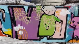 graffiti, kids street art, mural painting on a long low concrete wall