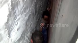 Claustrophobics look away! Man gets trapped between two walls while picking up dropped eggs