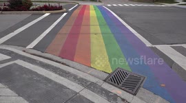 Gay pride rainbow flag painted at intersection by McMaster university campus in Hamilton Canada