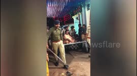Bizzare liquor Mafia lifted by cops with his bed as he is too heavy to walk in India street.