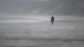 Beach Walker Battles Wind Drive Hailstones & Sand - Winter Weather
