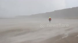 Dramatic moment storm hits Northern Ireland coast, leaving beach-goers battling horizontal hail and sand
