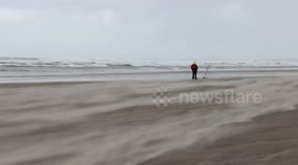 Fisherman takes on horizontal hail and sand during Northern Ireland storm