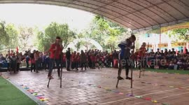 The racing on stilts by elementary school pupils
