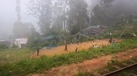 View from train in Sri Lanka (Kandy) - kids playing volleyball & dogs on the tracks