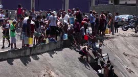 Scores of Venezuelans collect water from river as power outage crisis continues