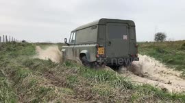 Land Rover Defender 110 drives through water