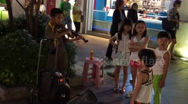 Thai student earn some extra income as street entertainers at Asiatique, Bangkok.