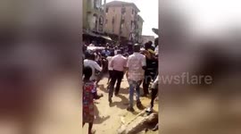School children being rushed to hospital after being rescued from the collapsed building in Lagos