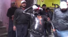 Hindu festival sees man paint himself jet black and smack people with tongs