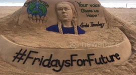 Sand artist create a sand sculpture on
