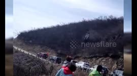 SUV tumbles down violently mountain before landing on another vehicle
