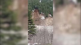 Dramatic footage shows live trees sliding down the hills onto the road in norther India