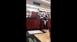 Woman drops bottle of wine in US shop