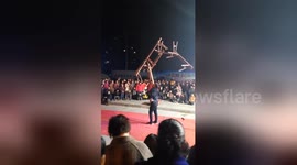 Chinese acrobat lifts up seven benches stacked onto his mouth