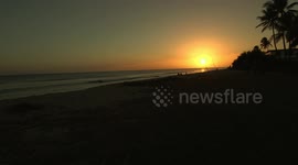Fisherman line sand on sunset beach