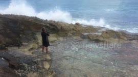 Waves Crash Into Cliff Man In Awe
