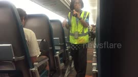 Flight Attendant Checks on Passengers
