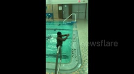 Gymnast makes powerful leap out of 42-inch pool onto edge