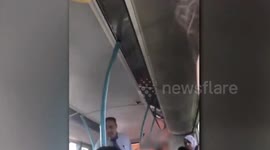 Shocking video shows two women landing blows on each other in the middle of a city bus in front of stunned passangers