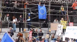 Supporters for a People's Vote mount scaffolding and hold EU flag aloft