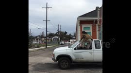 Man goes down slide on moving truck