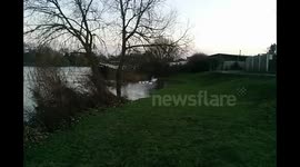 Swollen fast flowing river Thames in Laleham Surrey after server weather 2015