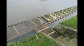 Swam hotel pontoon submerged by flooding Thames