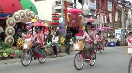 Beauty pageant contestants ride bicycles in Chiang Mai, Thailand