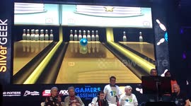 Crowd goes wild as elderly gamer scores a strike a bowling game competition