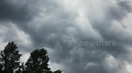 Stormy cloudy sky with a lightning striking.