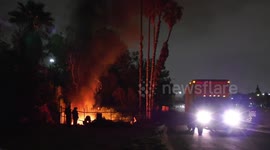 Firefighters Battle Rubbish Fire In LA, Firefighter Loses Control of Hose