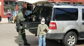 Young boy in awe as heavily armed police officer prepares for 'possible standoff' in Denver