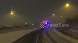 Snow plows out in force all night as heavy spring snow storm hits Toronto area making roads snow covers and slippery