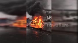 Out-of-control car crashes into guardrails and catches fire after missing scooter by inches