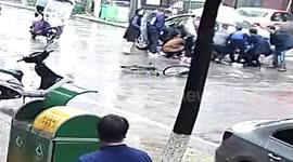 Good Samaritans in China lift car up together to save teen trapped underneath