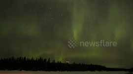 Canadian Winter Aurora from a frozen river in the city of Thompson Manitoba